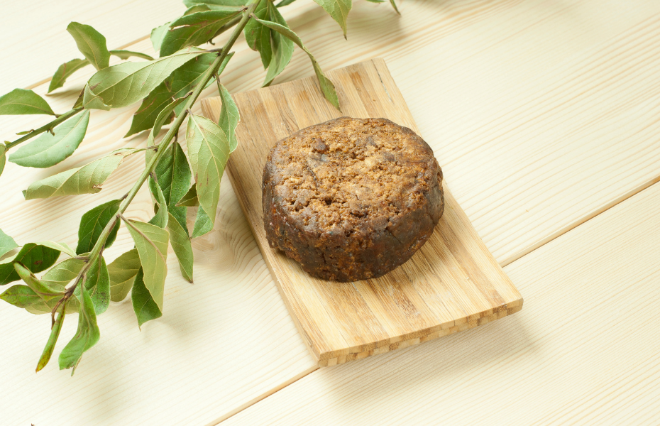 African Black Soap in a solid mould on a wooden soap dish