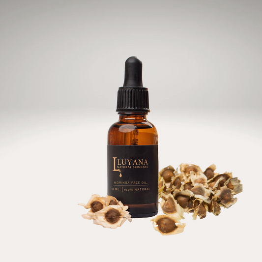 Amber glass bottle with Moringa Oil, surrounded by Moringa Seeds