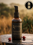 Luyana Skincare African Black Soap with Rosehip bottle on a stone surface with a blurred natural background