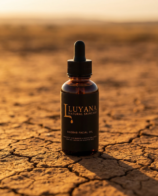 Luyana Skincare Baobab Oil in a dropper bottle on a cracked desert ground with a warm glow.