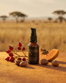 Luyana Skincare Brightening Serum in an amber pump bottle with natural ingredients on a desert background.