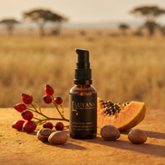 Luyana Skincare Brightening Serum in an amber pump bottle with natural ingredients on a desert background.