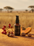Luyana Skincare Brightening Serum in an amber pump bottle with natural ingredients on a desert background.