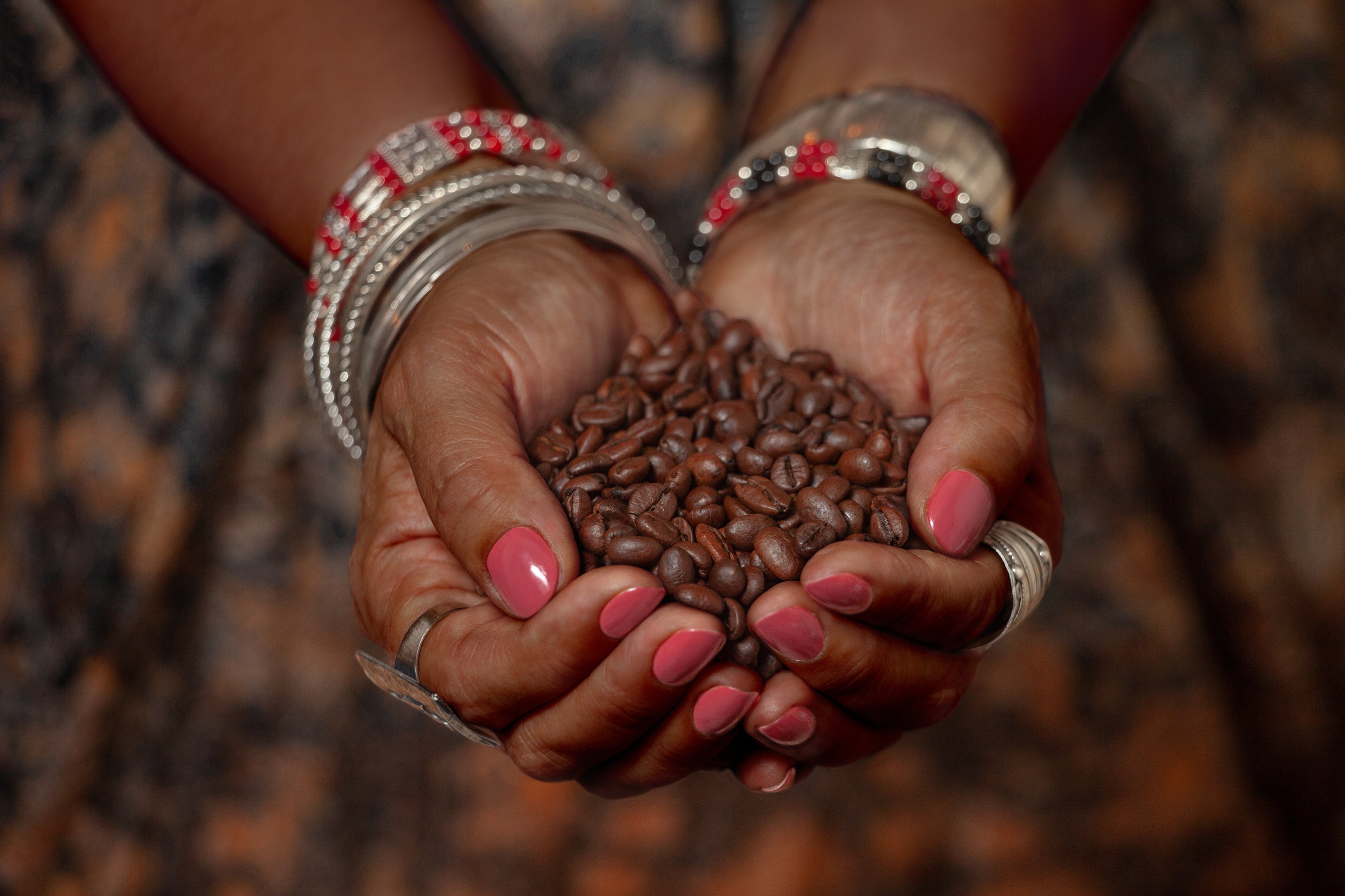 Woman holding coffee beans in her hands