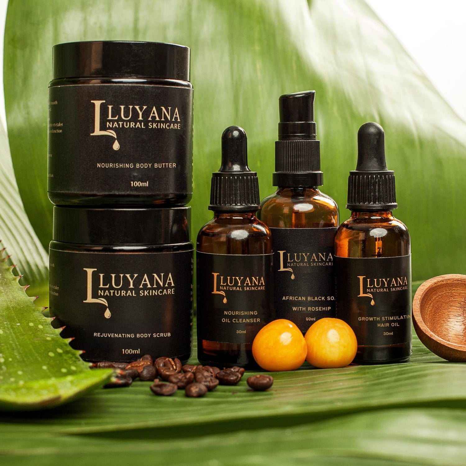 Group photo of Luyana Skincare products on a banana leaf with a wooden spoon