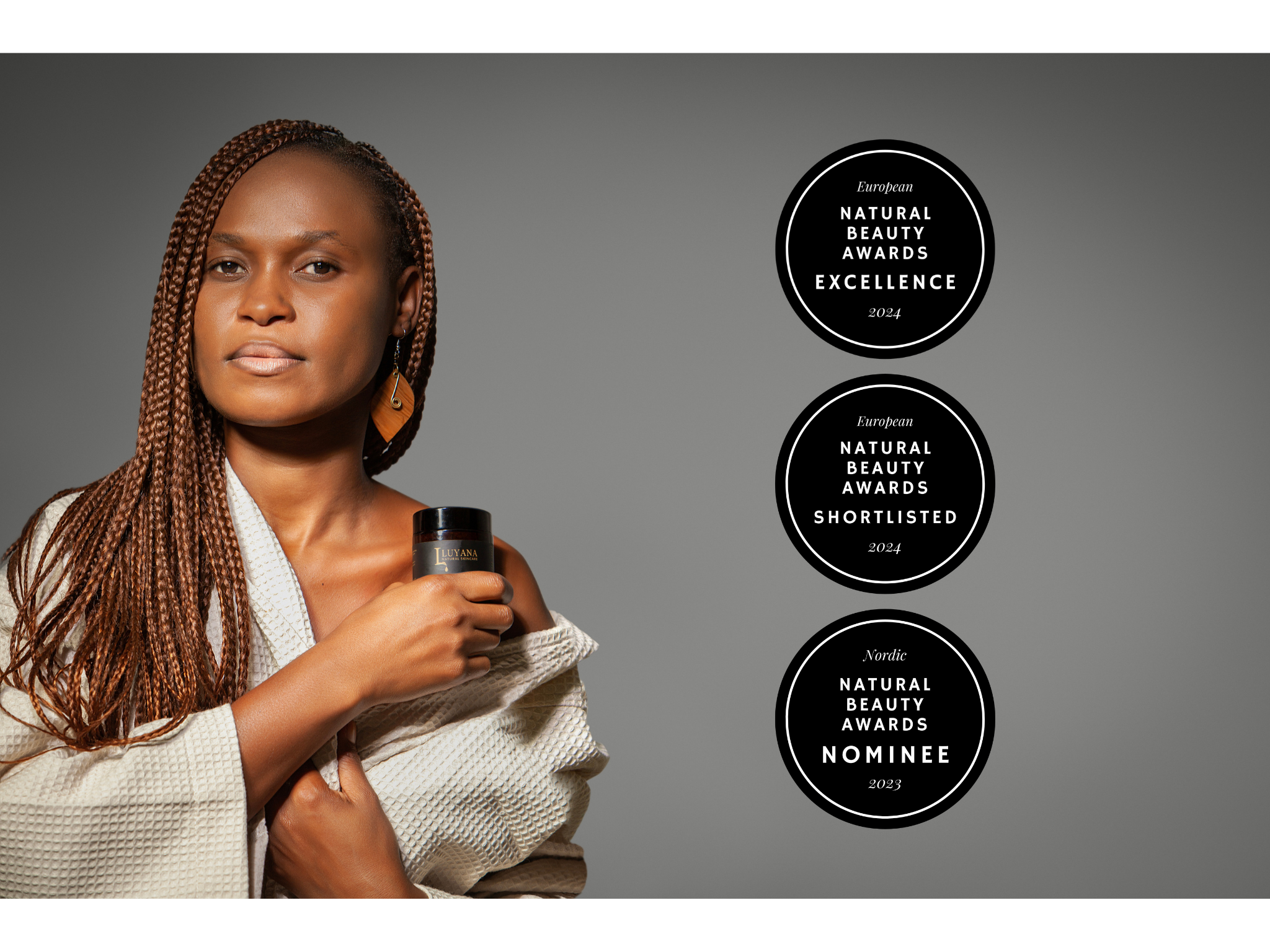 Header image of woman holding jar of Luyana Natural Skincare Nourishing Body Butter on grey background